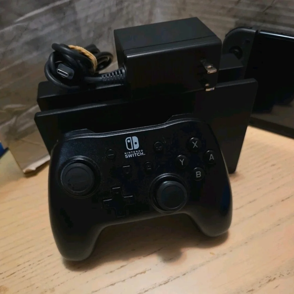 Nintendo Switch with Black Pro Controller and Blue Red Wired Controller